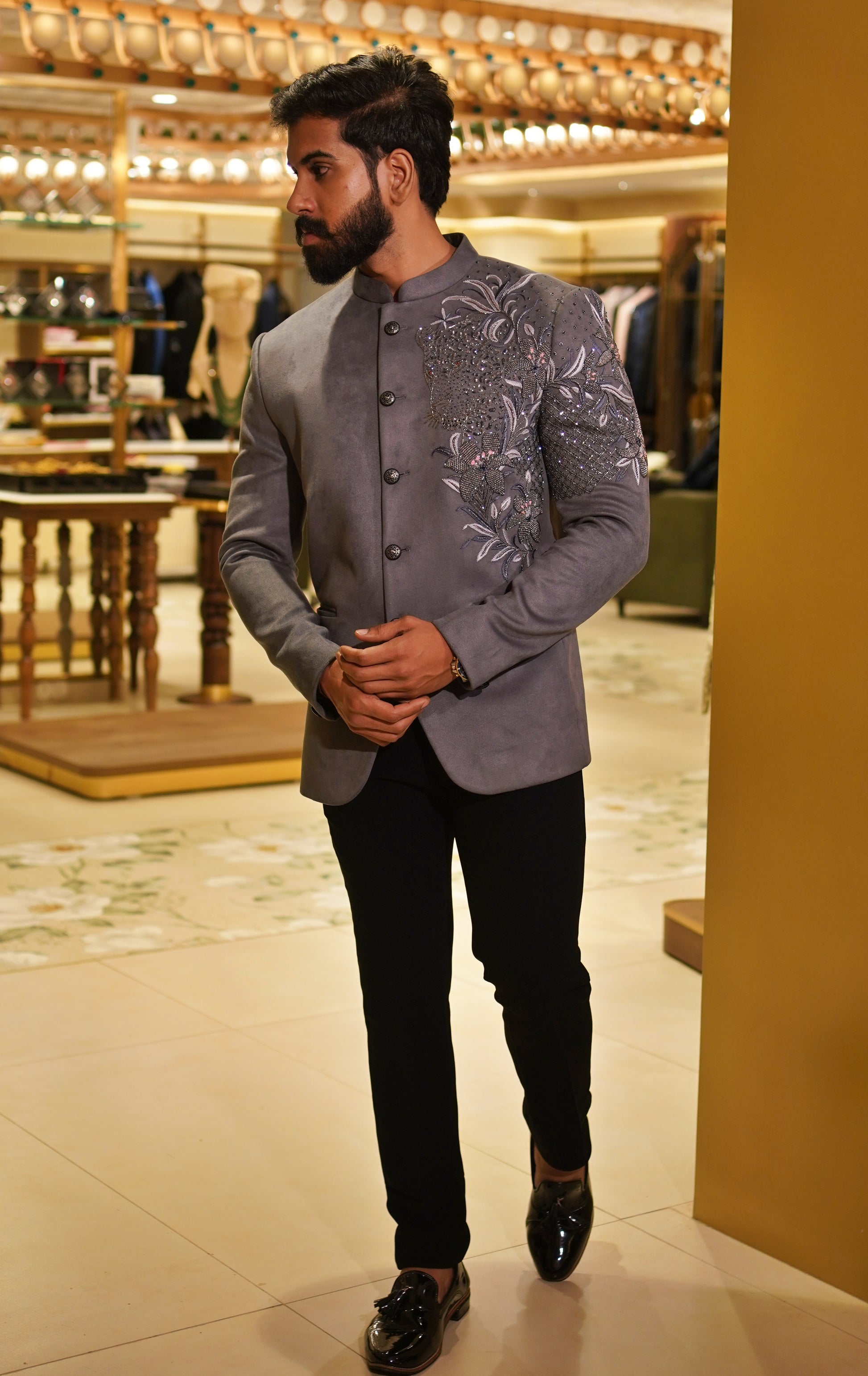 The Kadamba Jodhpuri in grey with intricate floral embroidery across the shoulder and sleeve